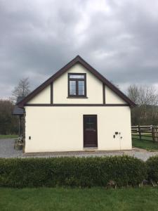 a white house with a black roof at Ty Erin in Llandeilo