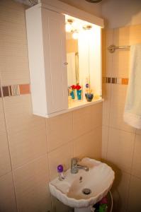 a bathroom with a sink and a mirror at Villa Conte Rari in Agios Gordios