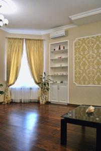 sala de estar con ventana grande y mesa en Nezhnyye Apartments en Odesa