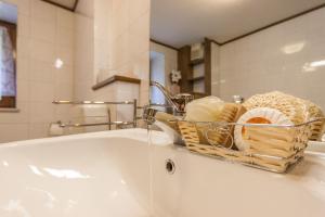 a bathroom sink with a basket of towels at Casa Silva in Falcade