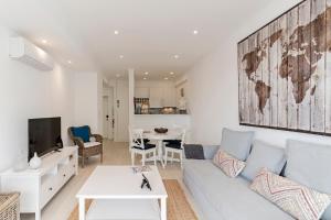 a living room with a couch and a table at Lido II by An Island Apart in Funchal