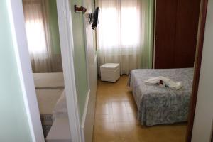 a small room with a bed and a window at Hostal Fabrellas in Caldes de Malavella