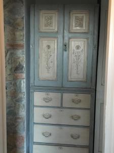 a blue cabinet with drawers in a room at La Nipitella in Montemarcello