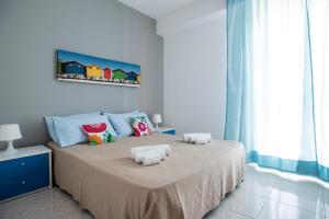 a bedroom with a bed with two pillows on it at Casa del Sole in Marina di Ragusa