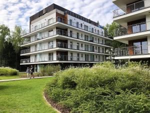 a large building with people walking in front of it at Family Apartment Golden Tulip in Międzyzdroje