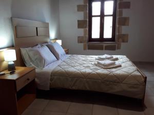 A bed or beds in a room at Traditional House Koukounara