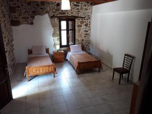 A bed or beds in a room at Traditional House Koukounara