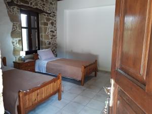 A bed or beds in a room at Traditional House Koukounara