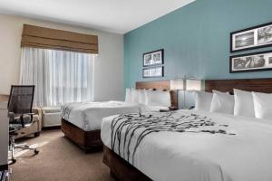 a hotel room with two beds and a window at MainStay Suites in Big Spring