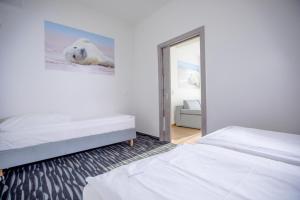 Postel nebo postele na pokoji v ubytování Apartamenty Villa Baltica Rewal - jacuzzi na dachu, wi-fi, parking w cenie