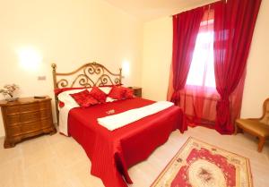 a bedroom with a red bed and a window at B&B Al Calcandola in Sarzana