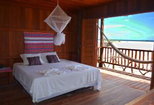 a bedroom with a bed with a view of the ocean at Casa Dunas da Barrinha in Barrinha