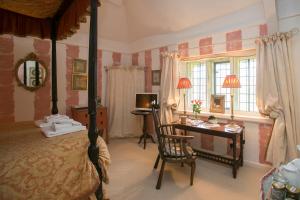 1 dormitorio con cama, escritorio y escritorio en Tudor Cottage B&B Frampton en Dorchester