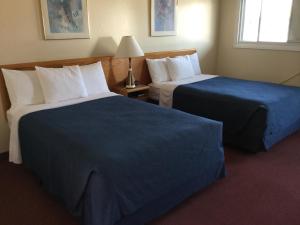 Posteľ alebo postele v izbe v ubytovaní Trunk Road Motel