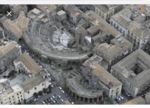 an aerial view of a city with a building at Luxurious Street Apartments in Catania