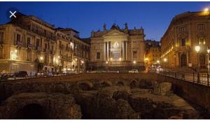 a city at night with a bridge and buildings at Luxurious Street Apartments in Catania