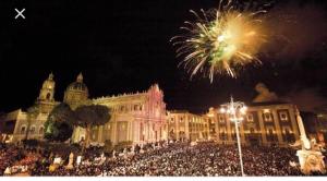 a large crowd of people in front of a building with fireworks at Luxurious Street Apartments in Catania