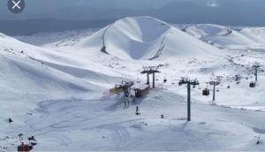 a snow covered ski slope with a ski lift at Luxurious Street Apartments in Catania