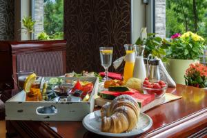 a table topped with a tray of food and drinks at Hotel Villa Harmony - Panoramic View & Free Parking in Sarajevo