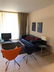 a living room with a couch and two chairs at Salgados Beach in Albufeira