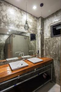 a bathroom with two sinks and a mirror at Yindee Travellers Lodge in Nan