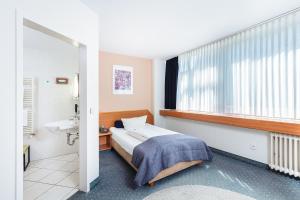 Postel nebo postele na pokoji v ubytování Hotel Servatius