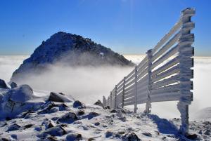 a fence on top of a mountain in the snow at Classy Apartment - Ski Telgart in Telgárt