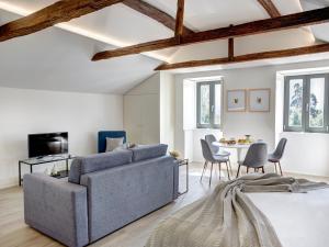 a living room with a couch and a table at Porto Downtown Lovers Suites: Bombarda 451 in Porto