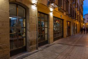an empty street in a city at night at Winederful Hostel & Café in Logroño