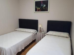 Posteľ alebo postele v izbe v ubytovaní Pension Loinaz