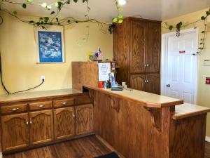 a kitchen with wooden cabinets and a counter top at Holland Inn & Suites in Morro Bay