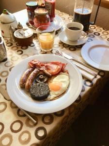 a plate of breakfast food on a table at The Lovecroft Guest House in Laide