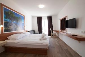 a bedroom with a bed with a teddy bear on it at Villa Amorena - Adults Only in Bol +18 photos