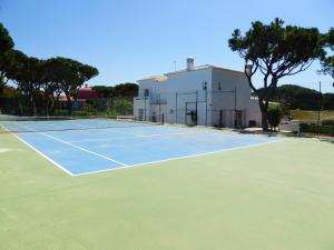 a tennis court in front of a building at Fonte Santa by Check-in Portugal in Quarteira