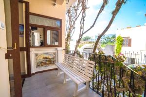 a balcony with a bench and a fireplace at Albergo Atlantic in Ischia