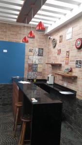 a kitchen with a sink and a counter top at Pousada Sognares in Guarulhos