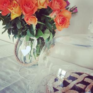 a vase filled with flowers on a table at Foresteria Villa Margherita in Colico