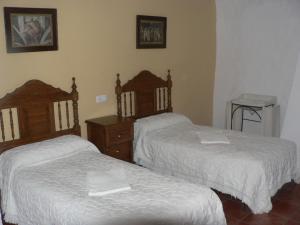 En eller flere senge i et værelse på Cortijo la Colá