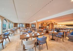 a restaurant with tables and chairs in a room at Cascade Wellness Resort in Lagos