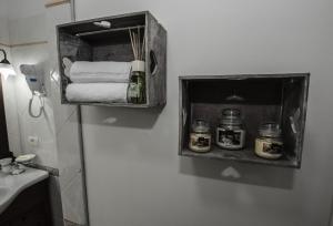 a bathroom with a towel dispenser on the wall at Villa Saturno in Tropea