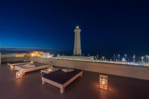 a lighthouse on the roof of a building at night at Casa del Faro in Torre Canne