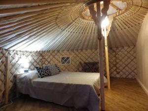 a bedroom with a bed in a yurt at La Cera Farm Camping B&B in Santa Teresa Gallura