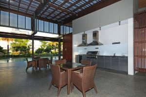 an open kitchen with a dining table and chairs at Allisee Apartments in Gold Coast