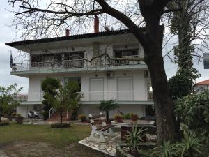 a white house with a bench in front of it at Litsa Haus Estate Residences & Suites - Adults Only & Kids 12 Plus- in Asprovalta