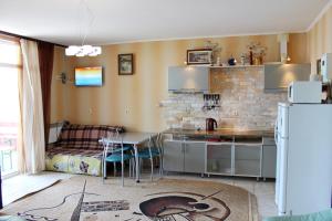 a kitchen with a table and a refrigerator at Sovinyon in Odesa