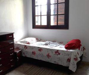 a small bed in a bedroom with a window at Pousada Sognares in Guarulhos