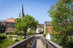 a bridge leading to a church with a steeple at Ferienwohnung Mittendrin in Baunach