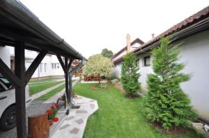 a house with a yard with trees and plants at Vila Hana in Nová Lesná