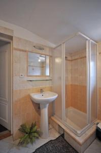 a bathroom with a sink and a shower at Vila Hana in Nová Lesná