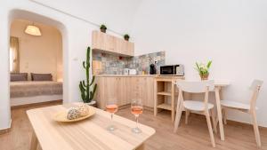 a living room with a table and two glasses of wine at MiCasa in Oia